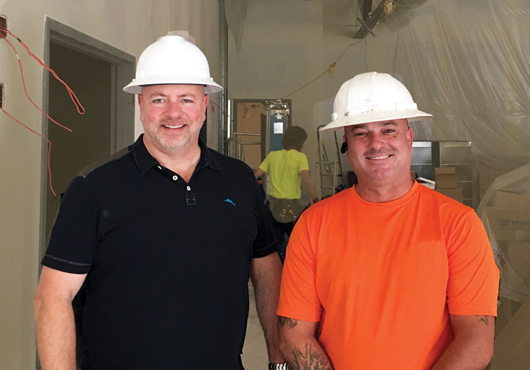 Inset: Richard Harris, President, and Simon Press, Operations Manager, consult at a Noble Modern Builders LLC project site.